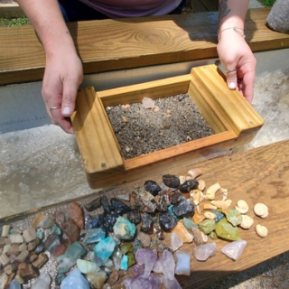 Close-up on sluice pan with gemstones<br />